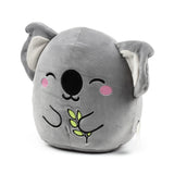 Angled front view of a soft, grey koala plush toy featuring embroidered smiling eyes, pink cheeks, a large black nose, and green leaves.