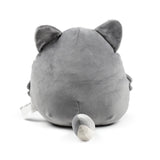 Back view of a round, grey wolf plush toy, showing its ears, two-toned tail, and a care label.