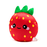 Angled view of a red strawberry plush toy with yellow embroidered seeds, bright green leaves, and a cheerful embroidered face showing a winking eye, a smile, and pink blushing cheeks, on a white background.