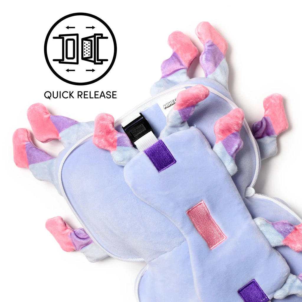 Overhead view of a lilac plush Minecraft Axolotl travel pillow, partially unzipped to reveal the internal white quick-release strap and buckle. It features pink, light blue, and purple gill-like accents.