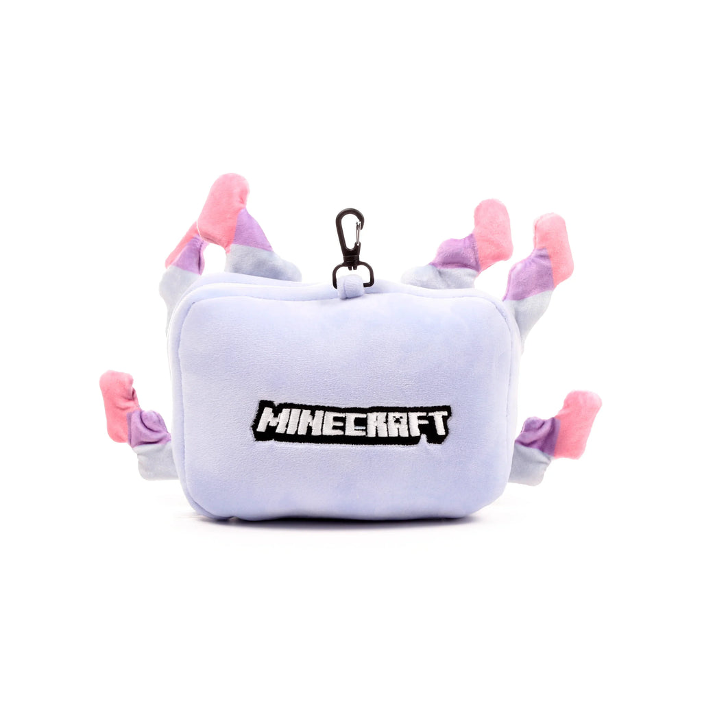 Front view of a plush light purple Minecraft Axolotl travel pillow, with embroidered 'MINECRAFT' lettering, pink, purple, and white gill-like details, and a black carabiner clip.