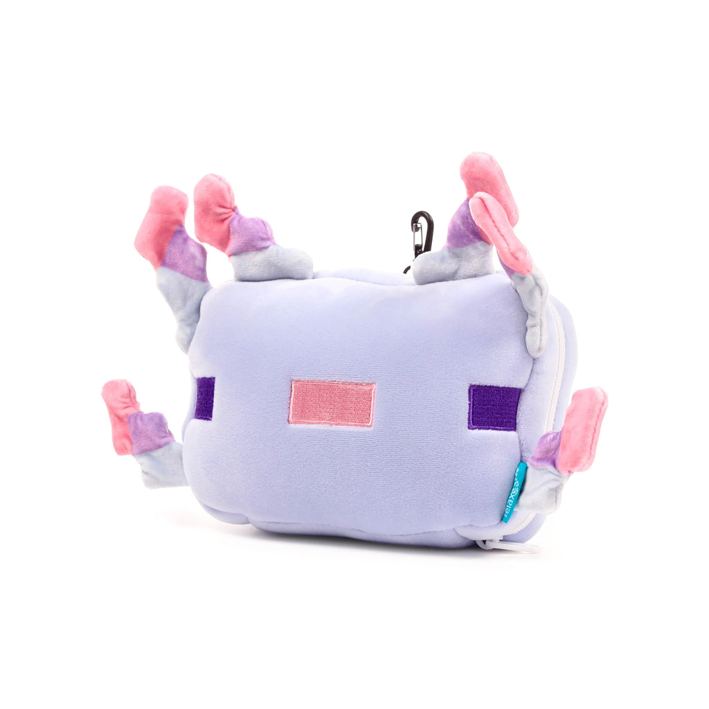 Angled view of a soft lilac Minecraft Axolotl travel pillow and eye mask set, featuring pink and dark purple embroidered pixel-style details on its body, six multi-coloured plush gills, a black carabiner clip, and a small light blue tag, against a white background.