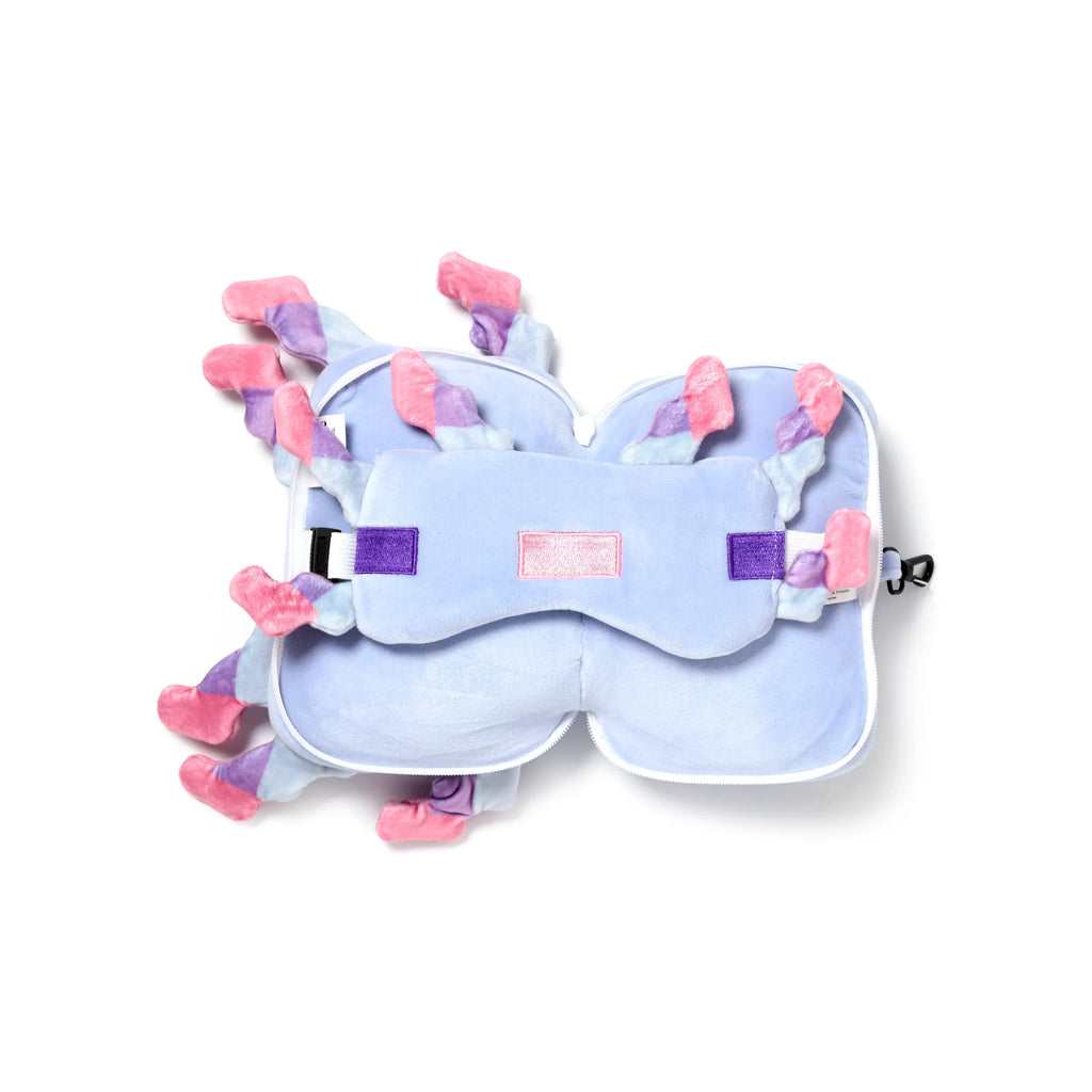 Overhead view of a folded light purple Minecraft axolotl travel pillow and eye mask set, displaying pink and purple frills, a white zipper, and a black clip.