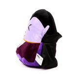 Angled view of a spooky Dracula plush toy, featuring a lilac face with embroidered closed eyes and white fangs, pointed ears, a dark purple body, and a black cape, on a white background.