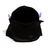 Rear view of a black plush Dracula toy, with two small, pointed purple ears protruding from the top of its head. A white care label is visible on the lower left.