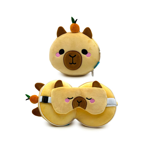 A light brown plush capybara travel pillow and eye mask set, displayed in two forms. The top item is a round, compact capybara toy with a small orange fruit on its head, facing forwards. Below, the U-shaped travel pillow is shown with the same small orange fruit and a matching capybara eye mask resting on top, both featuring embroidered capybara faces and small brown ears. A white adjustable strap is visible on the eye mask.