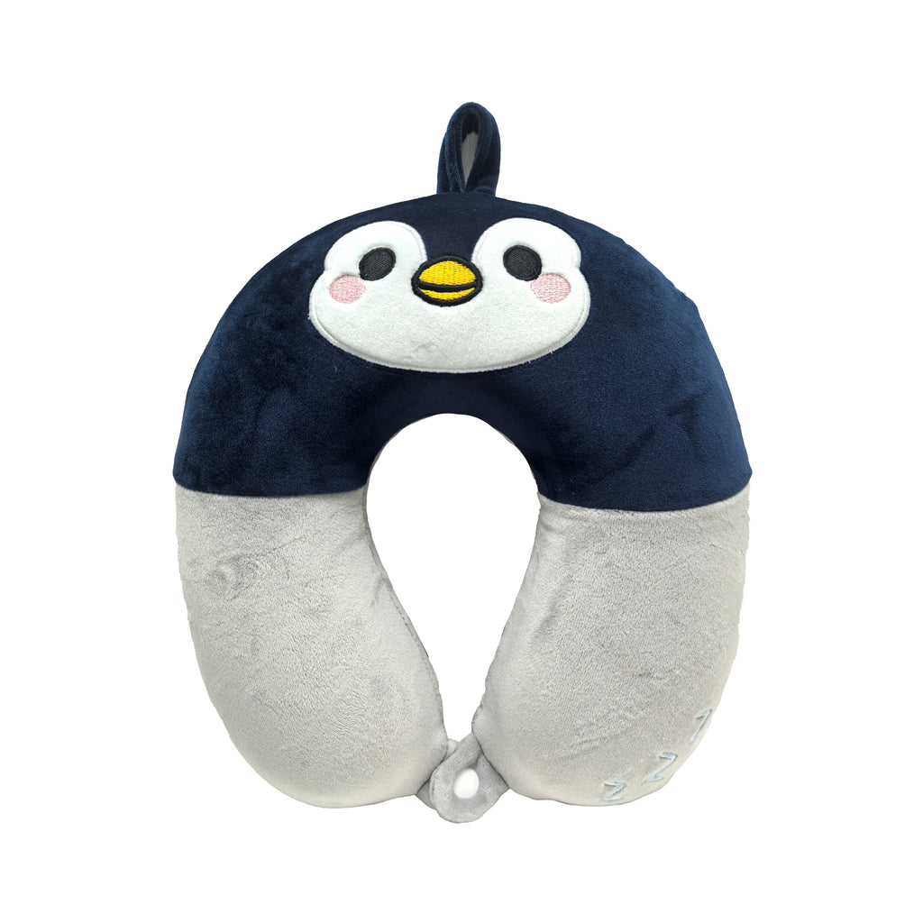 Front view of a plush dark blue and light grey kids memory foam travel pillow, shaped like a penguin with an embroidered face featuring black eyes, a yellow beak, and pink blush.
