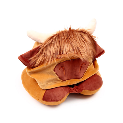 Front view of a plush Hairy Coos Highland Cow travel pillow and hood in brown and tan colours, featuring shaggy orange-brown faux fur, cream horns, and embroidered snout details.