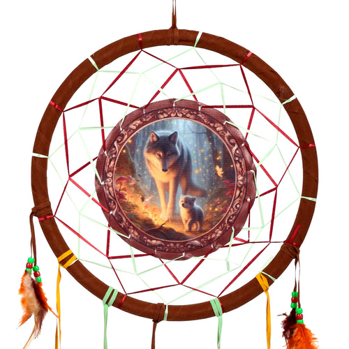 Front view of a dreamcatcher, with a central 'Fairy Dream' illustration depicting a grey wolf and cub in a glowing forest. The brown-wrapped hoop features a web of red and mint green ribbons, and is decorated with hanging orange and brown feathers and colourful beads.