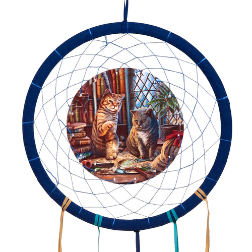 Front view of a blue fabric-wrapped dreamcatcher featuring a central Lisa Parker Purrlock Holmes Cat illustration of two felines investigating in a library, with tan and teal decorative ribbons.