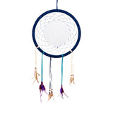Dark blue dreamcatcher with a light blue woven web and a plain white central disc, featuring hanging light blue, dark blue, and cream ribbons adorned with wooden beads and a mix of brown, purple, and reddish feathers.