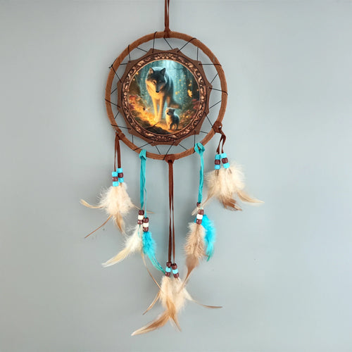 Small dreamcatcher, front view, featuring a central disc with a wolf and cub image, decorated with brown and turquoise beads and beige and turquoise feathers.