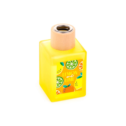 Angled front view of a yellow square reed diffuser bottle. It features a wooden collar, a silver-coloured insert, and a label depicting 'LEMON and LIME' text with vibrant fruit illustrations.
