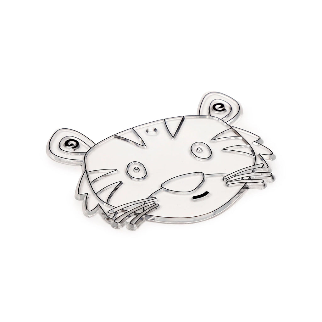 Angled view of a transparent DIY tiger head suncatcher blank, with black outlines for its facial features and stripes, and a small hanging hole at the top.