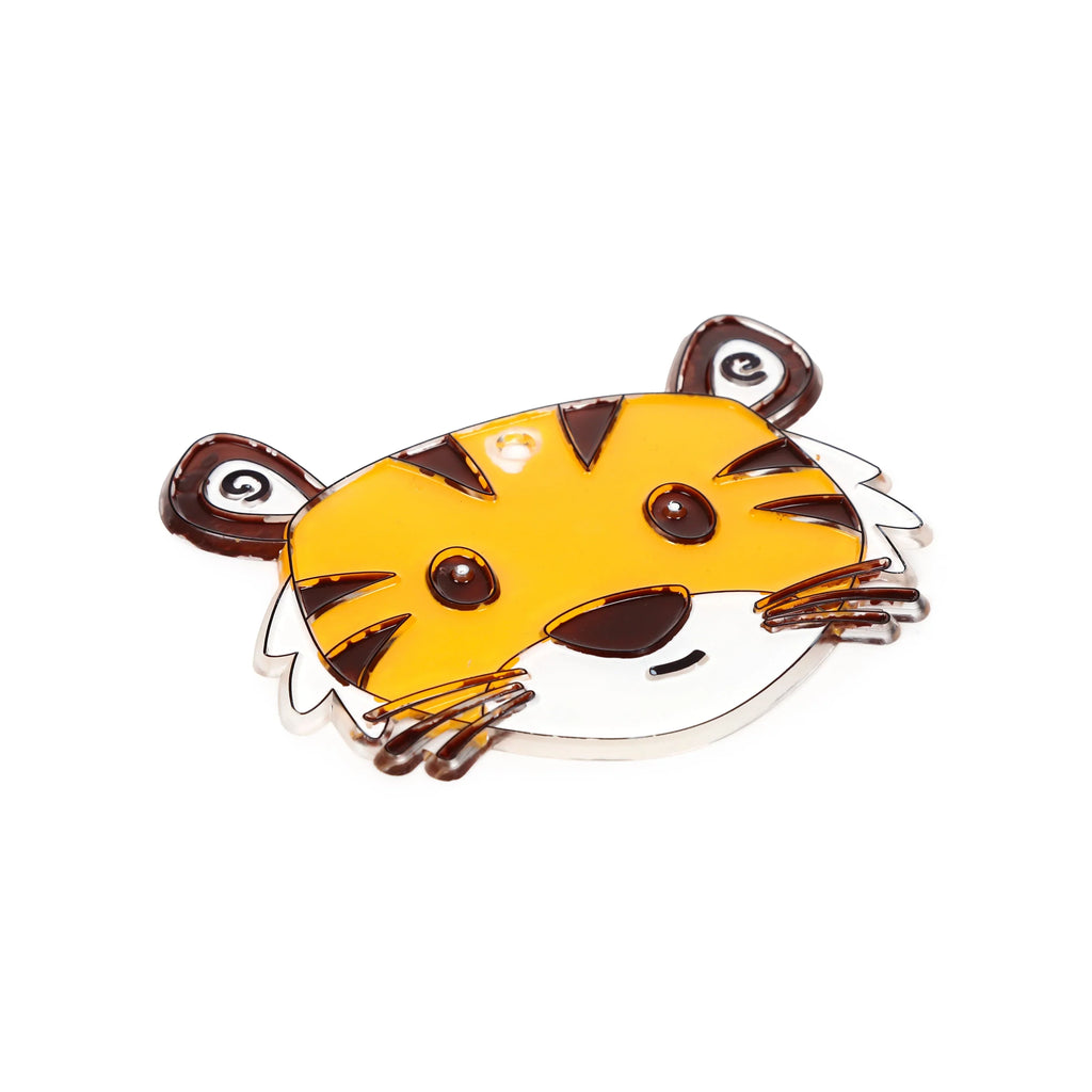 Angled view of a translucent DIY tiger head suncatcher, with prominent yellow and white coloured sections, dark brown outlines, and a small hole at the top for hanging.