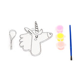 Overhead view of a DIY unicorn suncatcher kit, featuring a clear unicorn-shaped outline, three paint pots (pink, yellow, peach), a blue paintbrush, and a silver hanging cord, against a white background.