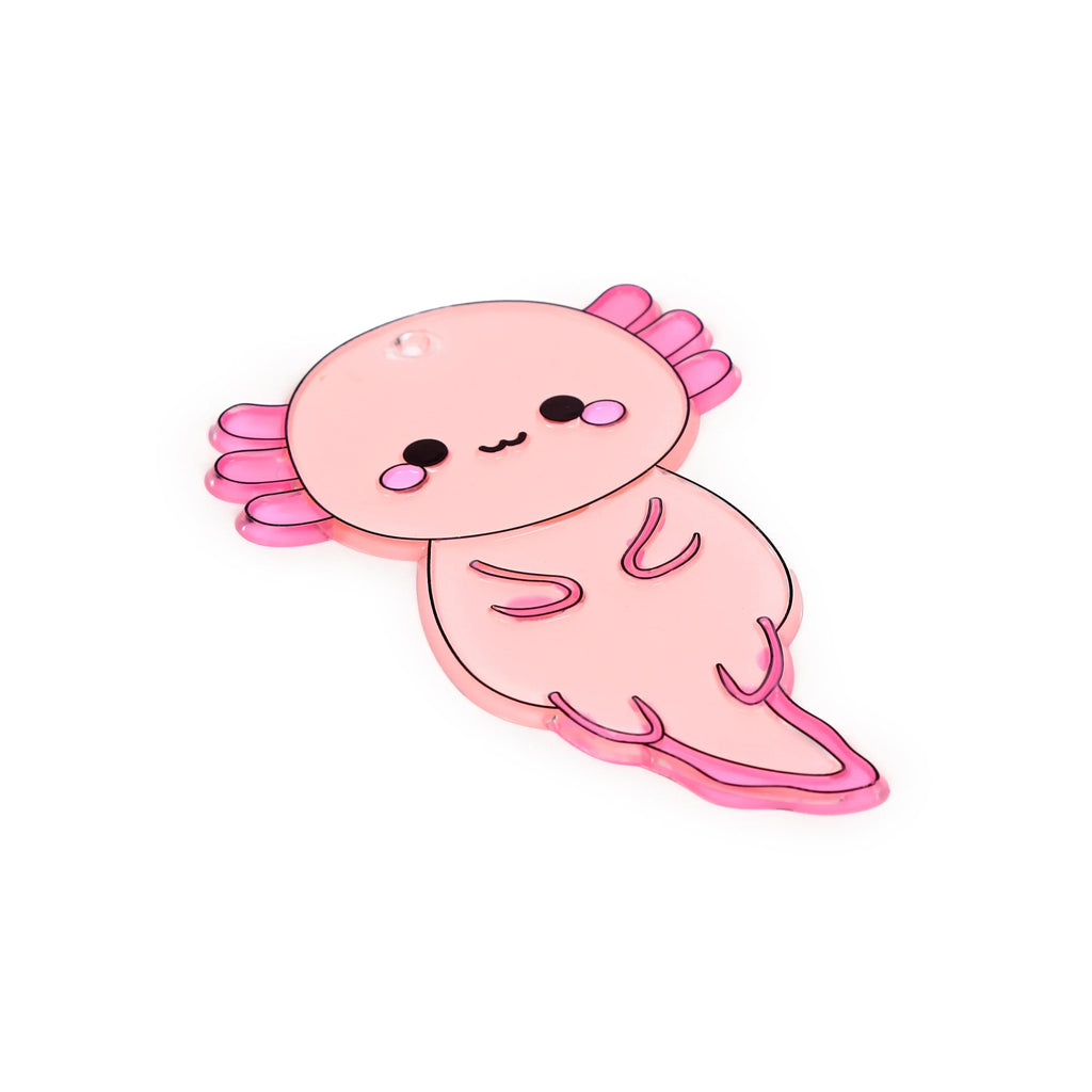 Angled view of a pink axolotl DIY suncatcher, with darker pink frilly gills, black eyes, and a smile, against a white background.