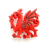 Close-up of a red Welsh dragon magnet in a rampant pose, featuring black detailing on its wings and claws.