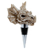 Angled view of a weathered off-white dragon skull bottle stopper, featuring sharp teeth, deep eye sockets, and horn-like spikes, set on a chrome stopper with black rubber rings.