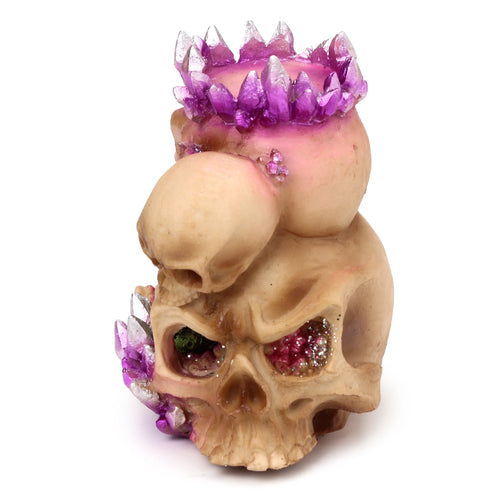 Front view of a crystal skull tea light holder with purple crystal formations, glitter, and a smaller secondary skull.