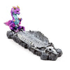 Angled view of a colorful baby dragon incense burner and ashcatcher, featuring a gray dragon skeleton base with a skull at one end.