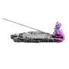 Side view of an ashcatcher incense burner featuring a grey dragon skeleton base with a vibrant purple, green, and gold baby dragon figure at one end, holding an incense stick. The product is shown on a white background.