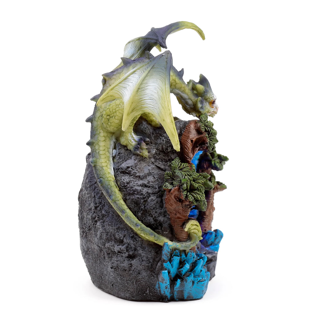 Right-hand angled view of a green and yellow baby dragon figurine on a rocky den with brown woodland details and bright blue crystal formations.