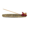 Front view of an antique gold ashcatcher incense burner featuring a red and gold dragon figure on one end, with carved mystical symbols along its tray, holding an incense stick.
