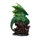 Front view of an emerald green dragon figurine, with large textured wings, perched on a gnarled dark brown base featuring small mushrooms.