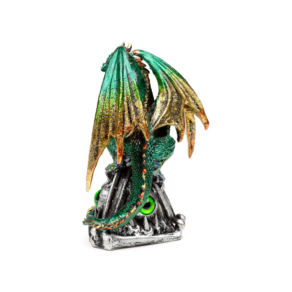 Rear view of a green and gold metallic-effect dragon figurine, featuring textured wings and a scaled tail, perched on a silver-coloured rock base with bright emerald eyes.