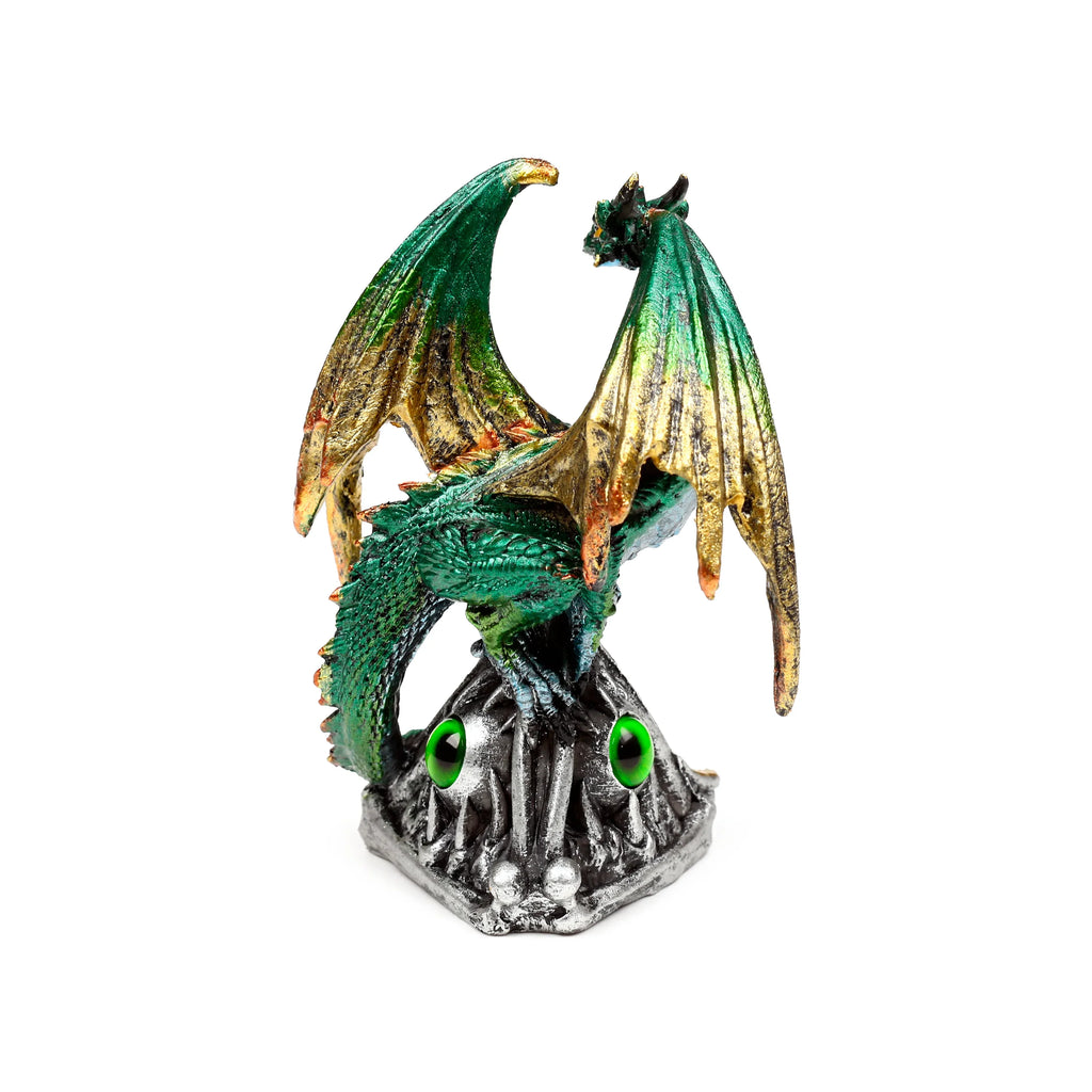 Angled view of a green and gold dragon ornament with spread wings, perched on a grey base featuring two prominent emerald green eyes.