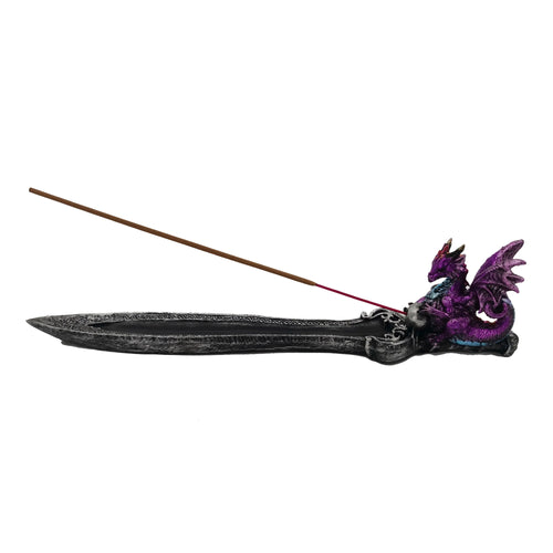 Angled view of an amethyst dragon incense burner, featuring a dark grey, intricately patterned holder with a brown incense stick inserted.
