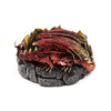 Angled view of a dark red and gold dragon incense burner, coiled around a dark grey, rock-textured base.