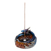 Angled view of a blue and purple dragon incense burner with an orange and red flame-patterned base, holding an upright incense stick.