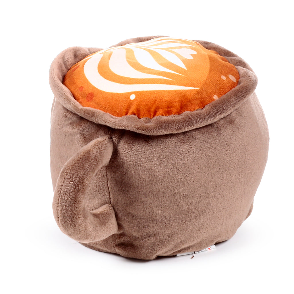 Angled view of a plush cappuccino door stop, warm brown with an orange-brown top featuring white latte art and a soft loop handle.