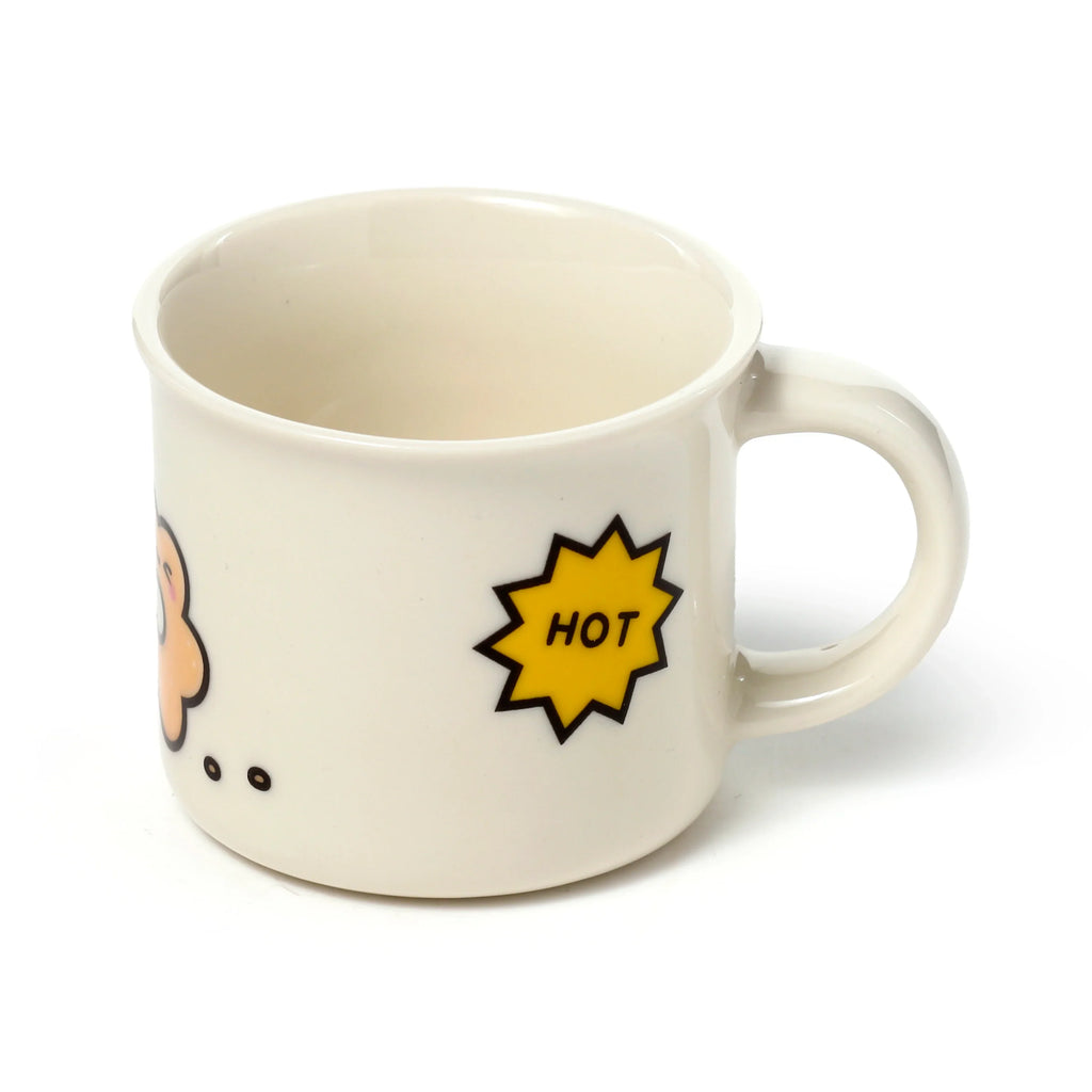 Angled view of a cream porcelain espresso cup with a partial cartoon character graphic and a yellow starburst with 'HOT' text.