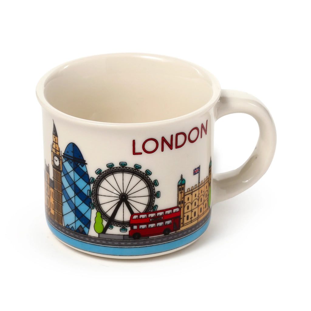 Front view of a cream porcelain espresso cup featuring colorful London icon illustrations: Big Ben, Gherkin, London Eye, a red double-decker bus, and the word 'LONDON', with a blue patterned base. White background.