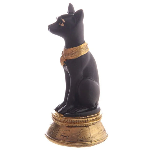 Angled side view of a decorative black and gold Bast Egyptian cat figurine ornament with a gold collar and patterned base, on a white background.