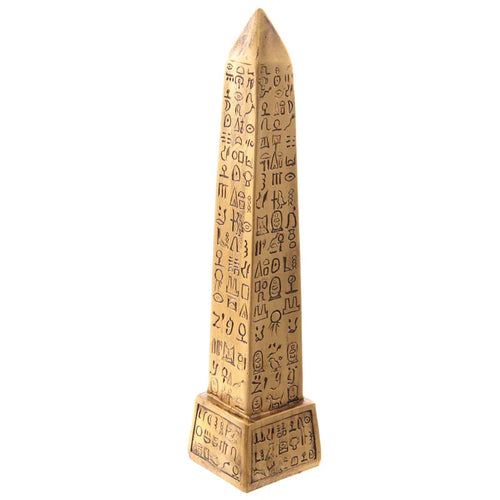 Front-side view of a decorative gold Egyptian obelisk ornament, featuring carved hieroglyphs, on a white background.