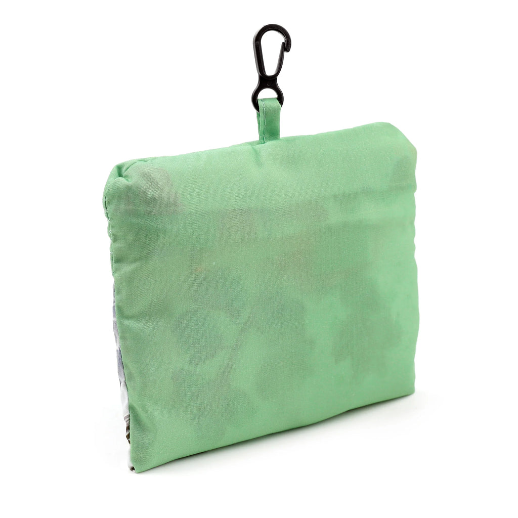 Angled product shot of a compact green foldable shopping bag with a black carabiner clip.