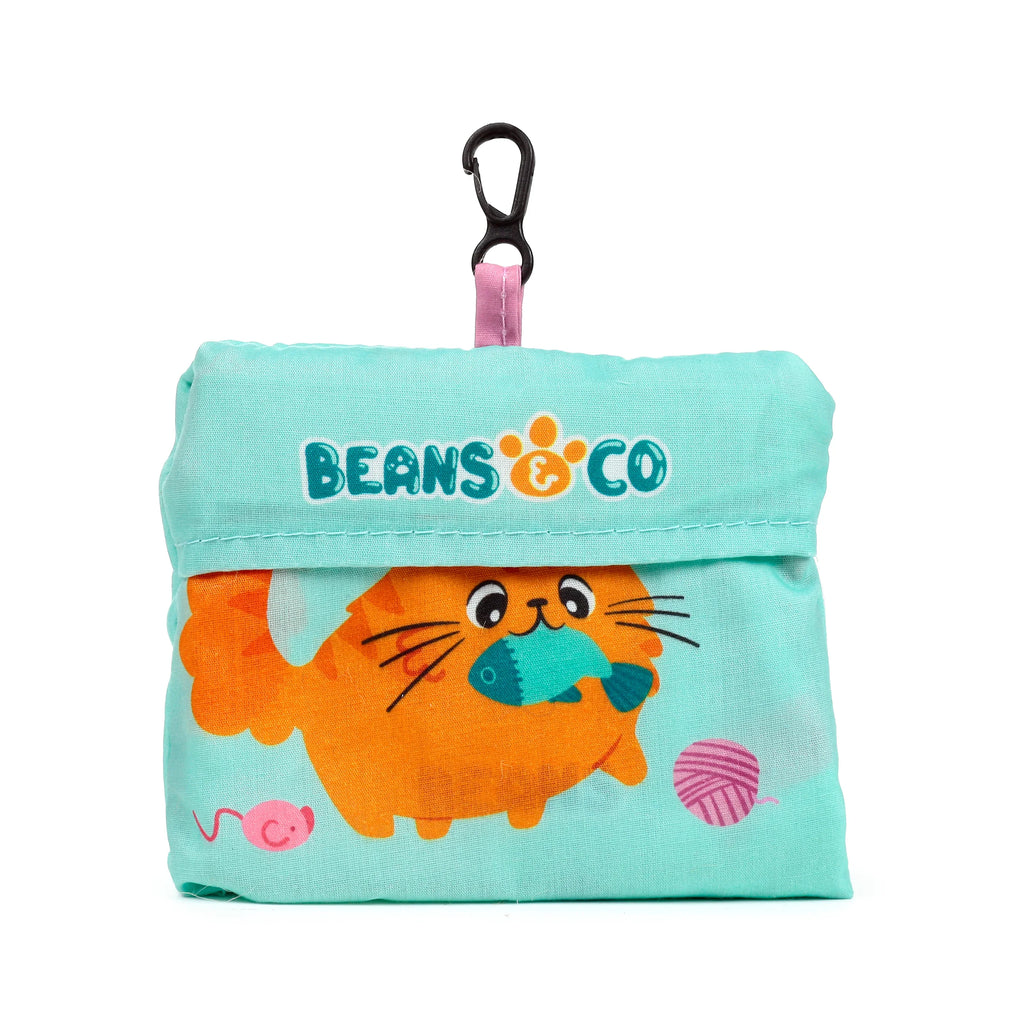 Front view of a turquoise foldable shopping bag pouch, featuring a cartoon orange cat holding a fish, 'BEANS & CO' text, and a black carabiner clip.