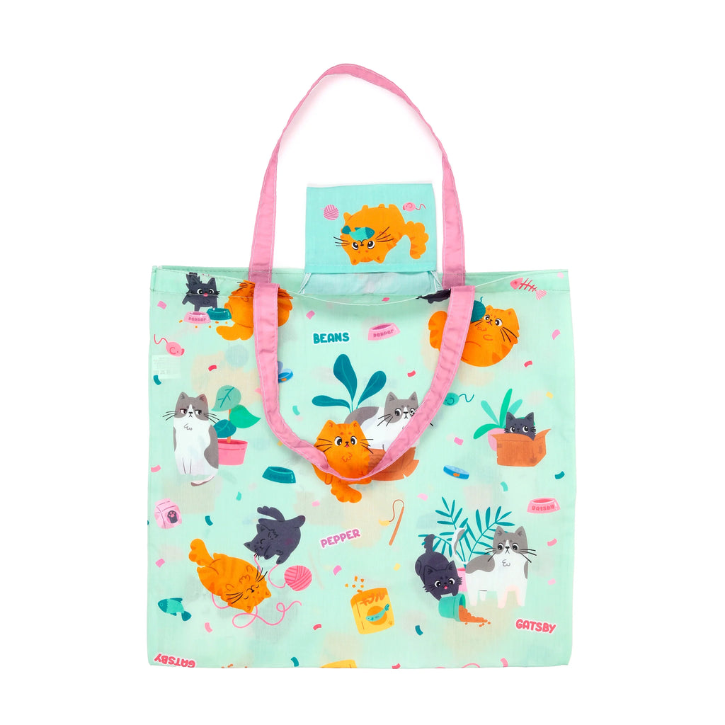 Front view of a mint green foldable RPET shopping tote bag with pink handles, featuring a playful pattern of various cartoon cats, yarn balls, and cat accessories.