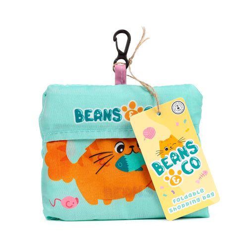 Front view of a folded mint green RPET shopping tote bag, featuring an orange cat holding a fish and a pink mouse design, with 'Beans & Co' text. A yellow product tag, displaying a cartoon cat, 'Beans & Co', 'Foldable Shopping Bag', and a 'Recycled Plastic' logo, is attached with twine and a black carabiner clip.