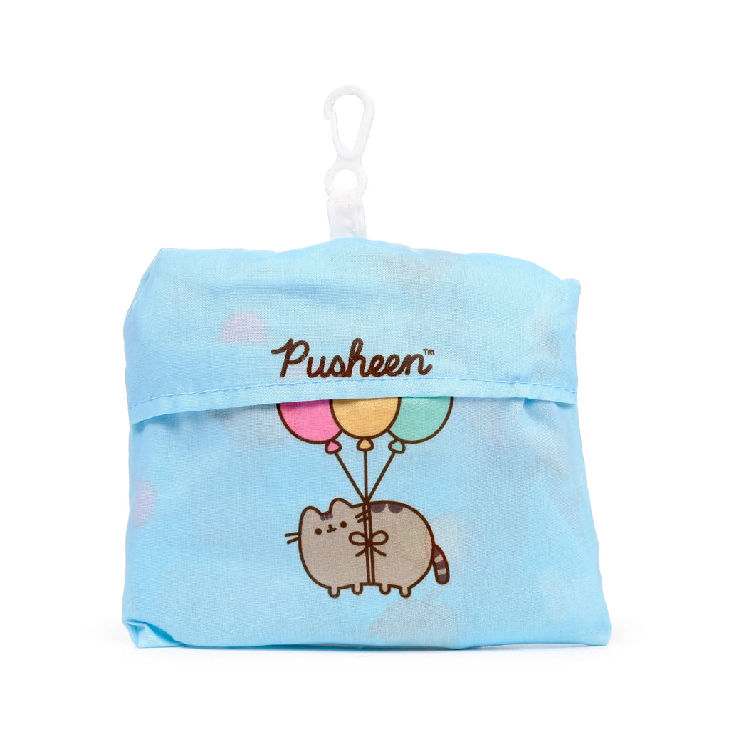 Front view of a light blue foldable RPET shopping tote, featuring Pusheen the Cat holding pink, yellow, and mint green balloons, with a white carabiner clip.