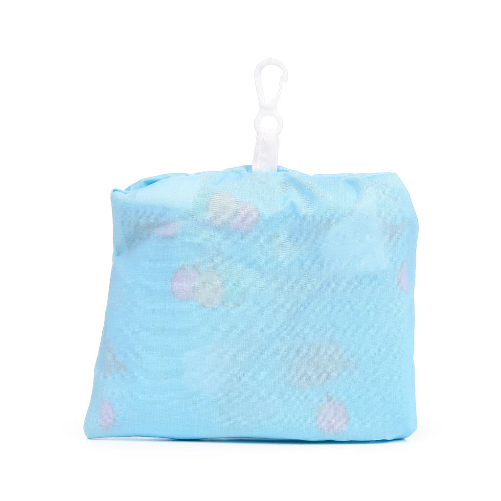 Front view of a light blue foldable shopping tote, neatly packed into its pouch, showing a faint pattern of pale balloon shapes and a white carabiner clip.