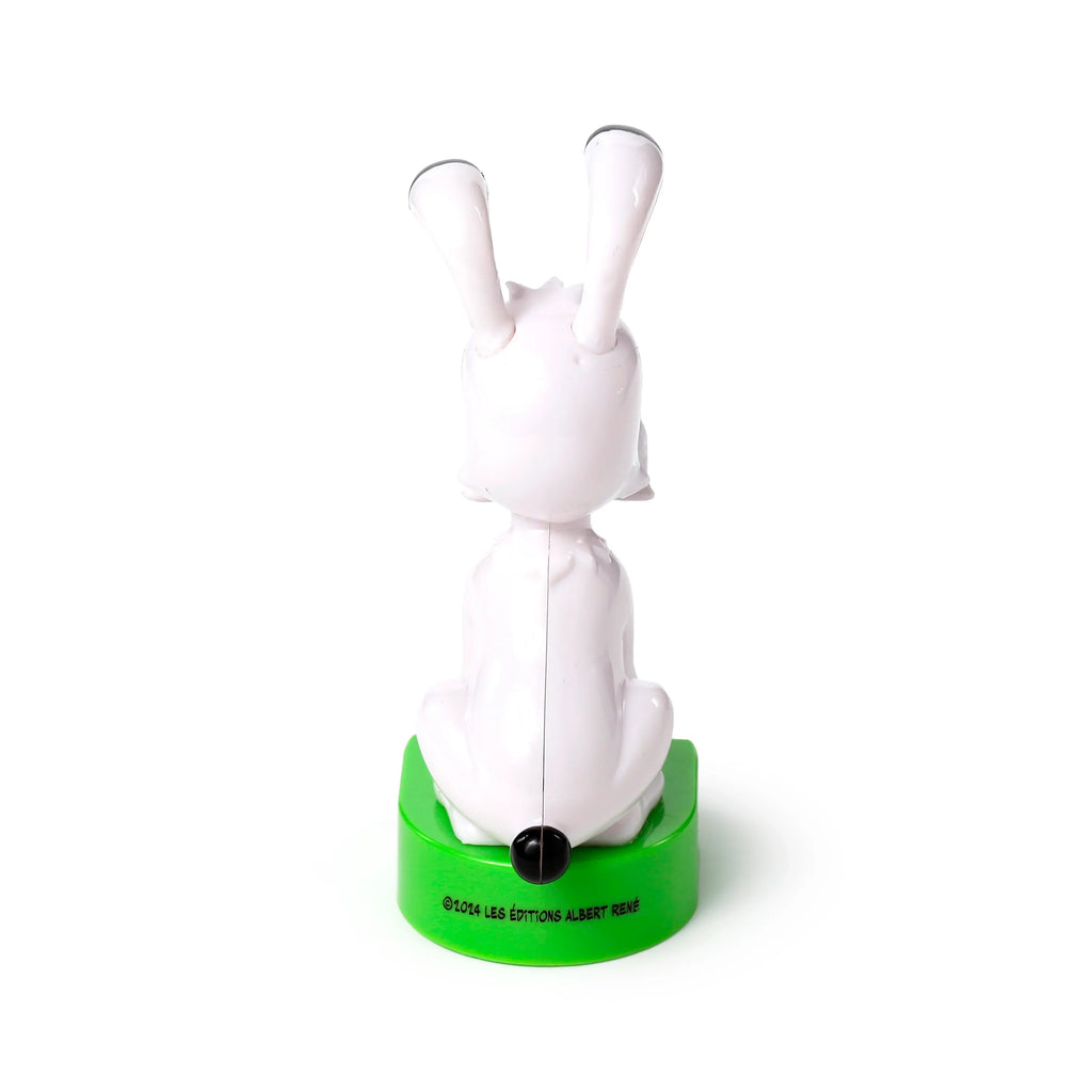 Back view of a white Idefix (Dogmatix) dog Solar Pal figure with prominent ears and a small black tail, seated on a bright green base.