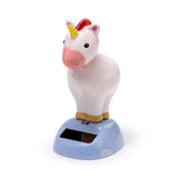 Front-side view of a white unicorn Solar Pal figure with a yellow horn, red mane, and pink snout, standing on a light blue base with white cloud details and a solar panel.