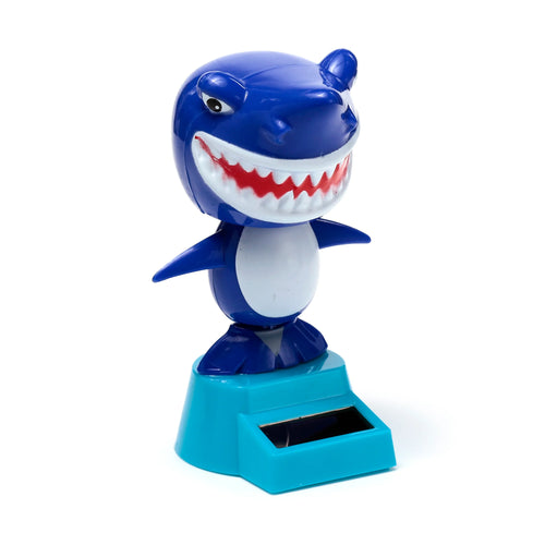 Angled view of a blue and white cartoon shark Solar Pal bobble head, with an open mouth showing red gums and white teeth, standing on a teal and dark blue solar-powered base.