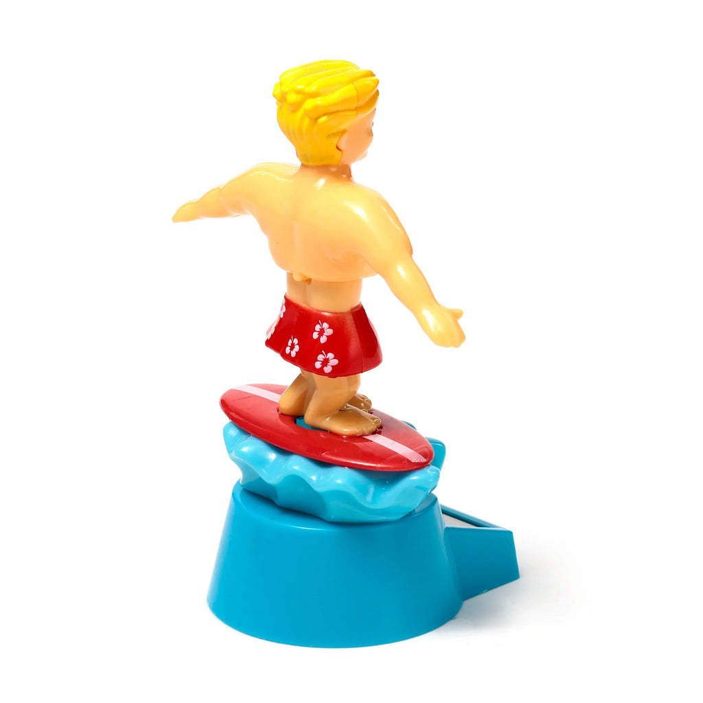 Rear view of a blonde-haired Solar Pal Surger Dude figurine, wearing red floral shorts and balancing on a red surfboard with a white stripe, atop a blue wave-shaped base, on a white background.