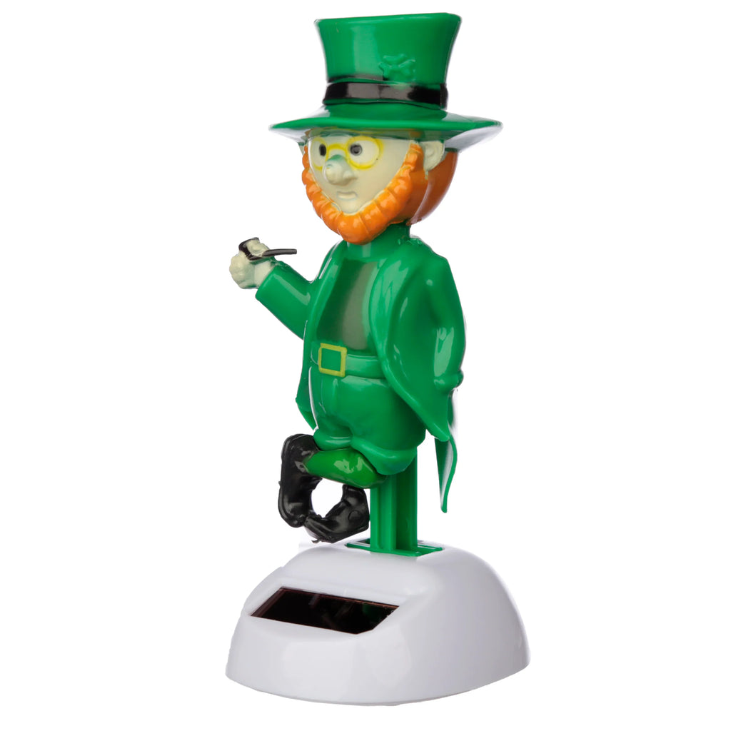 Front view of a green-clad leprechaun solar pal figure with an orange beard, yellow spectacles, and a green top hat featuring a shamrock detail. The leprechaun holds a black pipe and is seated on a green stem, attached to a white base with a visible solar panel.